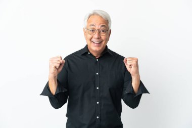 Middle age Brazilian man isolated on white background celebrating a victory in winner position