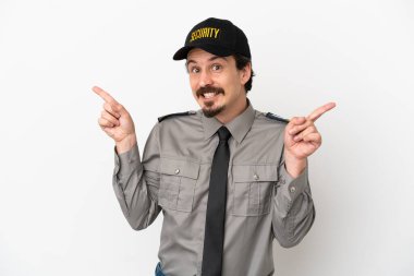 Young caucasian security man isolated on white background pointing finger to the laterals and happy