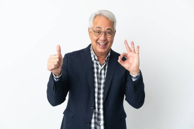 Middle age Brazilian man isolated on white background showing ok sign and thumb up gesture