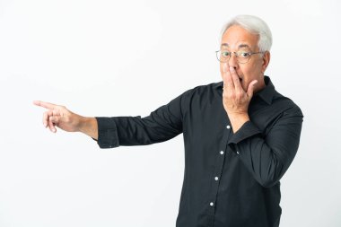 Middle age Brazilian man isolated on white background with surprise expression while pointing side