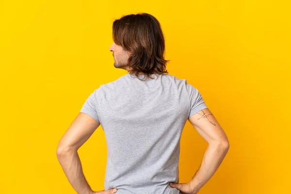 Young Handsome Man Isolated Yellow Background Back Position Looking Side — Stock Photo, Image