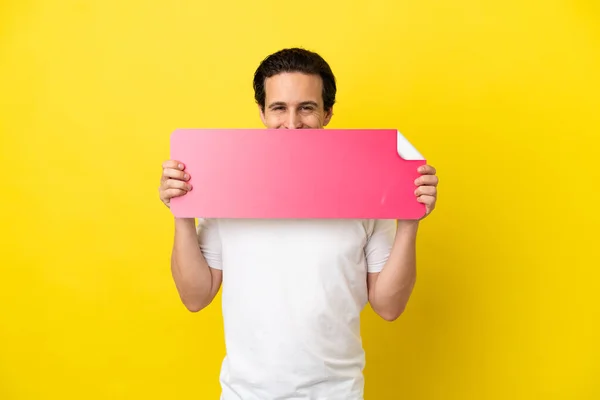 Young Caucasian Man Isolated Yellow Background Holding Empty Placard Hiding – stockfoto