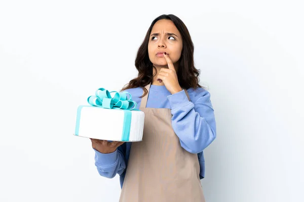 Pastry Chef Holding Big Cake Isolated White Background Having Doubts — Stock Photo, Image