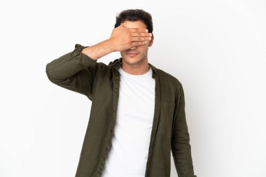 İzole edilmiş beyaz arka planda beyaz tenli yakışıklı adam gözlerini elleriyle kapatıyor. Bir şey görmek istemiyorum.