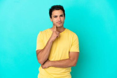 Kafkasyalı yakışıklı adam soyutlanmış mavi arka plan ve düşünce