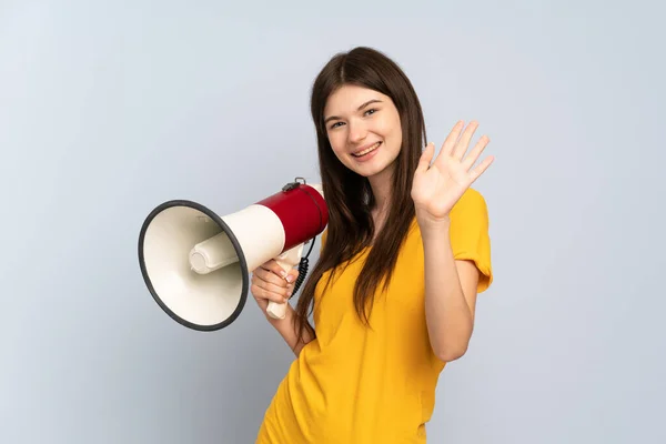 Young Ukrainian Girl Isolated White Background Holding Megaphone Saluting Hand — ストック写真