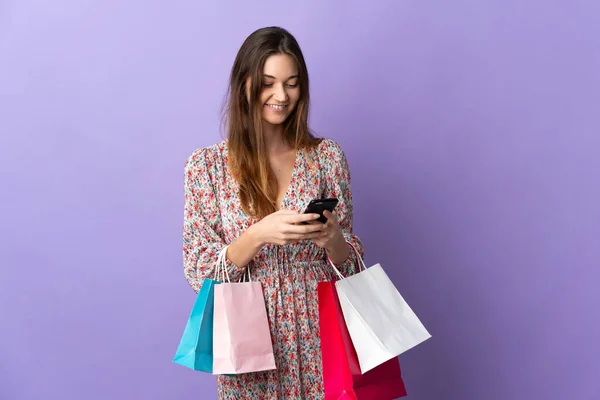 Mujer Joven Irlanda Aislada Sobre Fondo Púrpura Sosteniendo Bolsas Compra — Foto de Stock