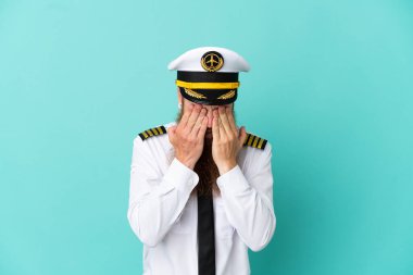 Redhead caucasian man playing rugby isolated on yellow background with tired and sick expression