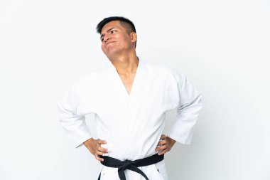 Young Ecuadorian man doing karate isolated on white background suffering from backache for having made an effort