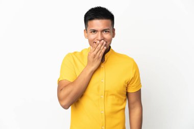 Young Ecuadorian man isolated on white background happy and smiling covering mouth with hand