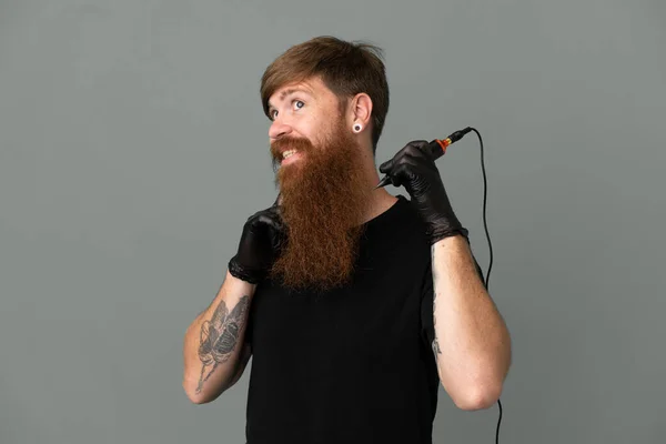 Tattoo Artist Redhead Man Isolated Blue Background Looking While Smiling — Stockfoto