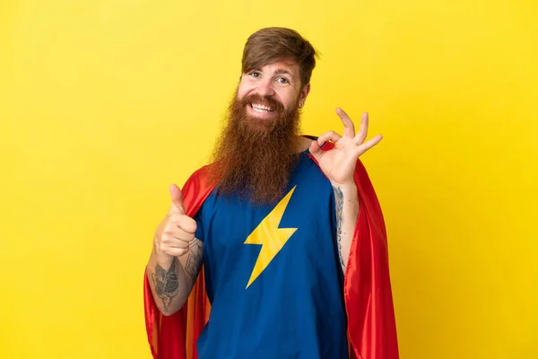 Redhead Super Hero Man Isolated Yellow Background Showing Sign Thumb — Stock fotografie