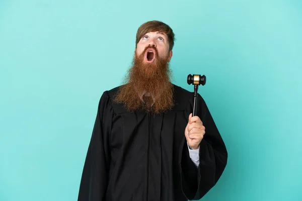 Redhead Caucasian Judge Man Isolated Blue Background Looking Surprised Expression — Stockfoto