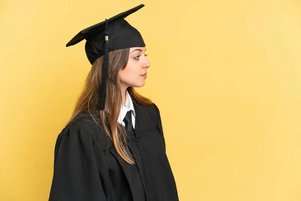 Young University Graduate Isolated Yellow Background Looking Side — Stok fotoğraf