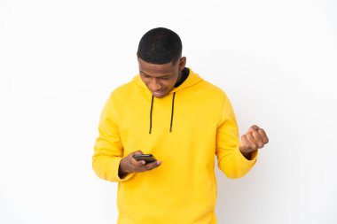 Beyaz arka planda izole edilmiş genç Latin adam şaşırdı ve bir mesaj gönderiyor.