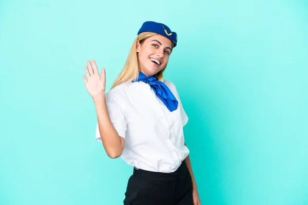 Airplane Stewardess Uruguayan Woman Isolated Blue Background Saluting Hand Happy — Stock Photo, Image