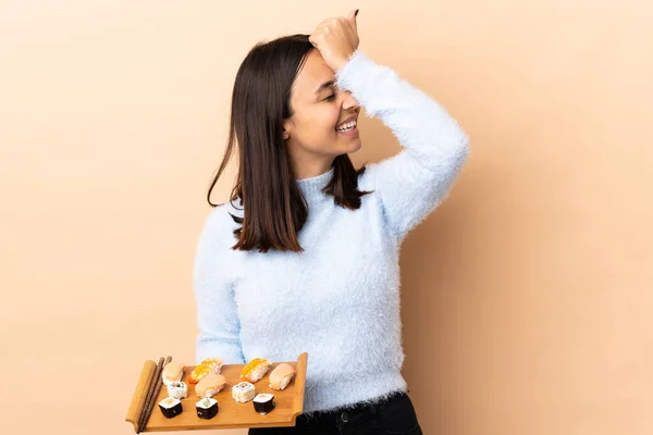 Junge Brünette Mischlingsfrau Die Sushi Über Isoliertem Hintergrund Hält Hat — Stockfoto