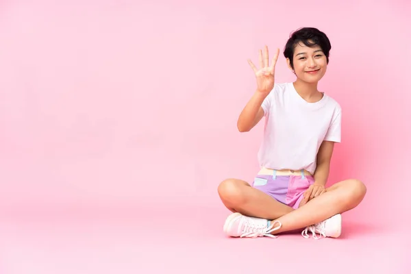Young Vietnamese Woman Short Hair Sitting Floor Isolated Pink Background — Stock Photo, Image