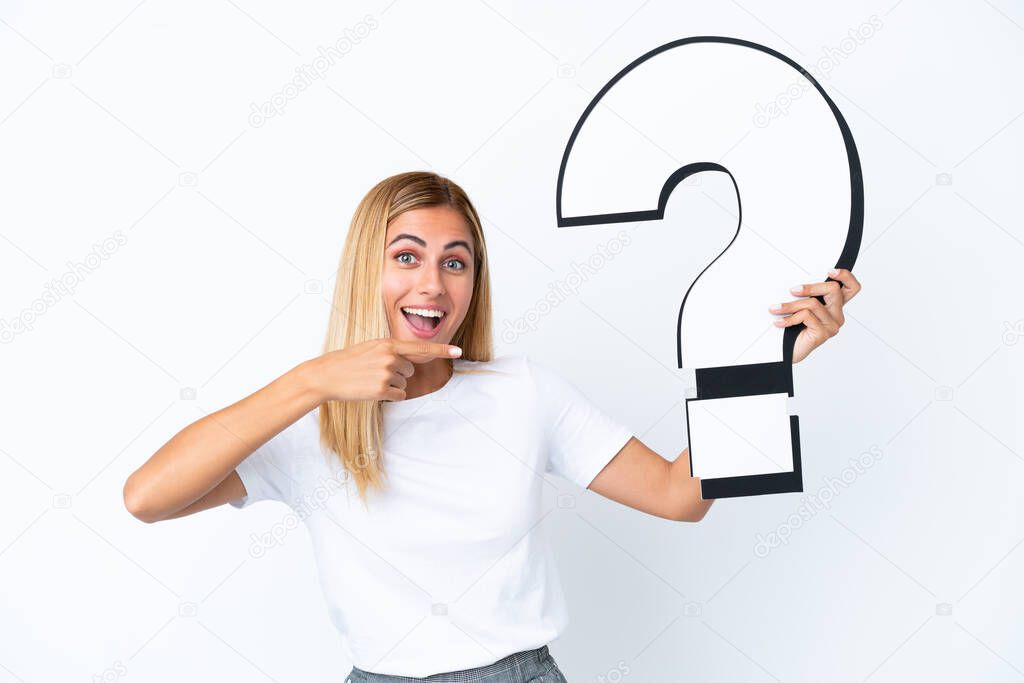 Blonde Uruguayan girl isolated on white background holding a question mark icon with surprised expression