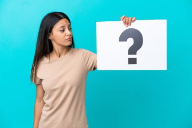 İzole edilmiş arka plan üzerinde soru işareti olan bir pankart tutan genç bir kadın.