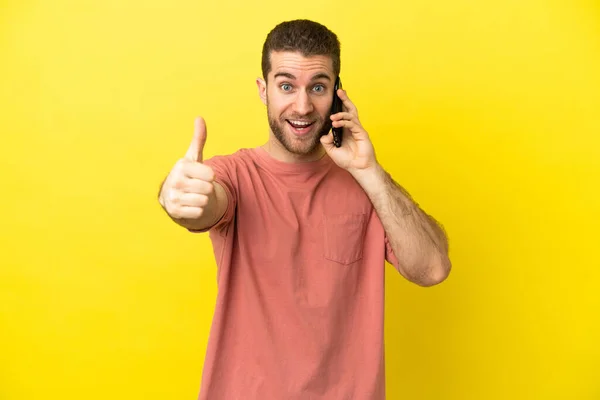 Handsome Blonde Man Using Mobile Phone Isolated Background Thumbs Because — Stock Photo, Image
