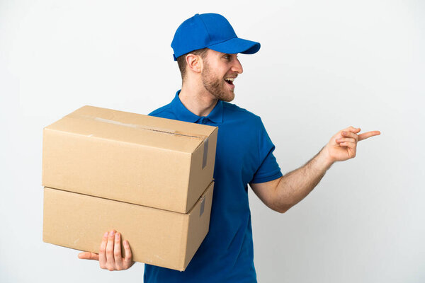 Delivery man over isolated white background pointing finger to the side and presenting a product