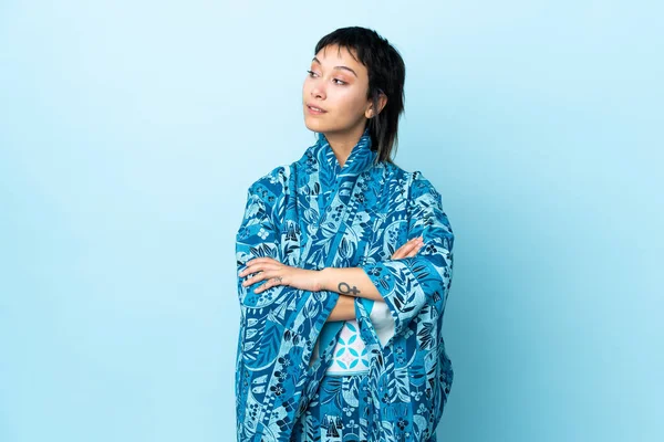 Mujer Joven Con Kimono Sobre Fondo Azul Aislado Mirando Hacia —  Fotos de Stock