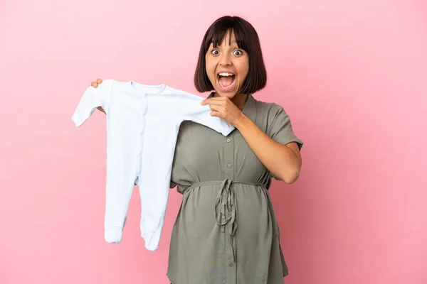 Woman Isolated Background Pregnant Holding Baby Clothes Surprised Expression — Stock Photo, Image