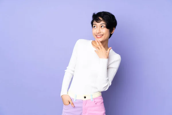 Young Vietnamese Woman Short Hair Isolated Purple Background Looking While — Stock Photo, Image