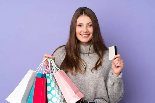 Tiener Kaukasisch Meisje Geïsoleerd Paarse Achtergrond Holding Boodschappentassen Een Creditcard — Stockfoto