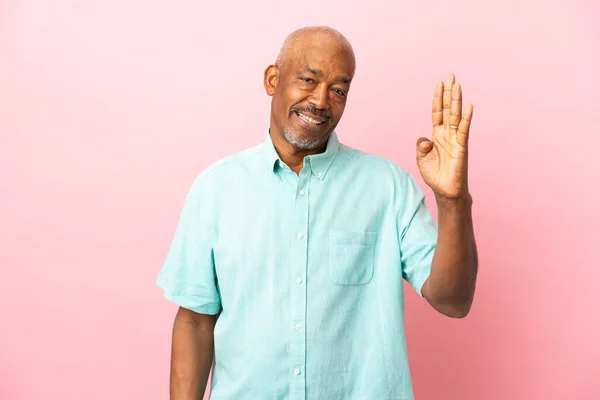 Cuban Senior Isolated Pink Background Saluting Hand Happy Expression — Stock Photo, Image