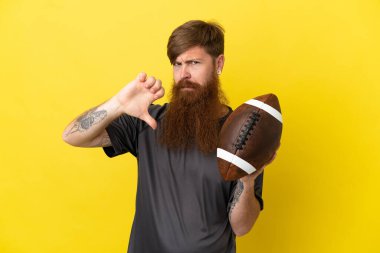 Kızıl saçlı beyaz adam sarı arka planda ragbi oynuyor.