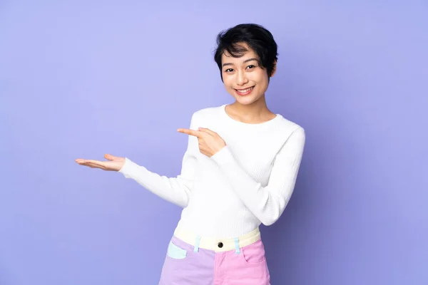 Young Vietnamese Woman Short Hair Isolated Purple Background Holding Copyspace — Stock Photo, Image