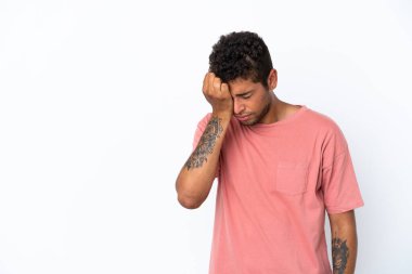 Genç ve yakışıklı Brezilyalı bir adam beyaz arka planda baş ağrısı ile izole edilmiş.