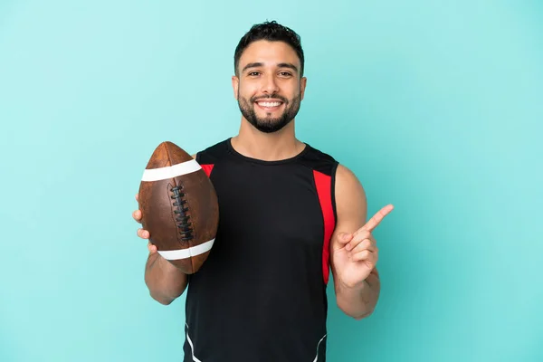 Young Arab Man Playing Rugby Isolated Blue Background Pointing Side — Stock Photo, Image