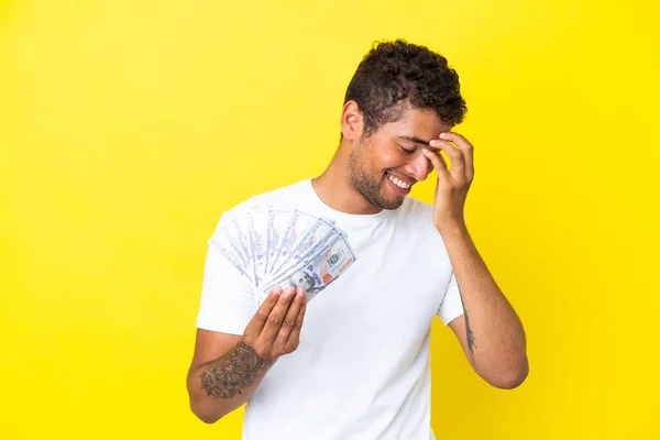 Jonge Braziliaanse Man Neemt Veel Geld Geïsoleerd Gele Achtergrond Lachen — Stockfoto