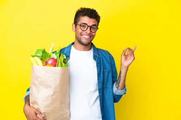 Young Brazilian Man Holding Grocery Shopping Bag Isolated Yellow Background — Stock Photo, Image