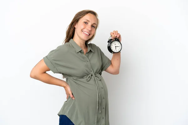 年轻的高加索妇女被隔离在白色背景下 怀孕和保持时钟 — 图库照片