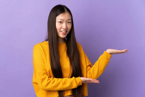 Молода Китайська Дівчина Через Ізольоване Фіолетове Тло Простягає Руки Бік — стокове фото
