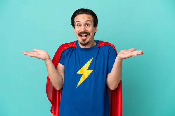 Super Hero Caucasian Man Isolated Blue Background Shocked Facial Expression — Stock Photo, Image