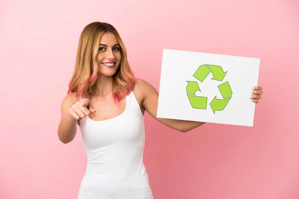 Jovem Sobre Fundo Rosa Isolado Segurando Cartaz Com Ícone Reciclagem — Fotografia de Stock
