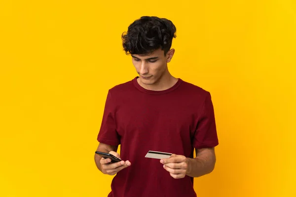 Arjantinli Genç Adam Sarı Arka Planda Izole Edilmiş Cep Telefonuyla — Stok fotoğraf