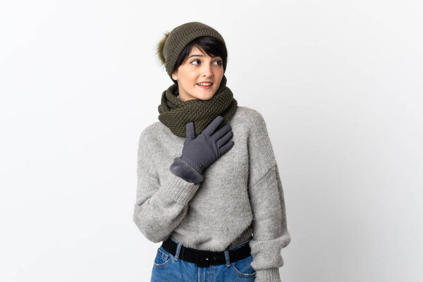 Young girl with winter hat looking up while smiling