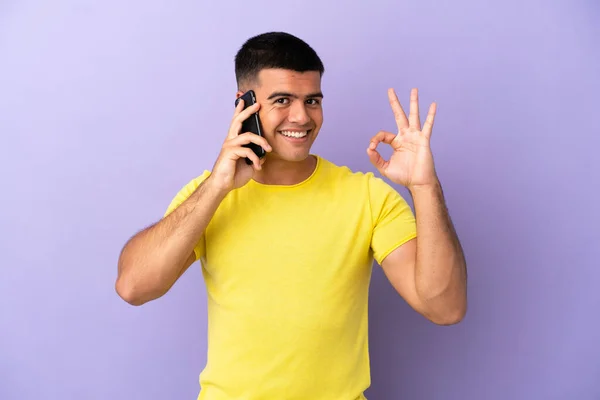 Young Handsome Man Using Mobile Phone Isolated Purple Background Showing — Stock Photo, Image