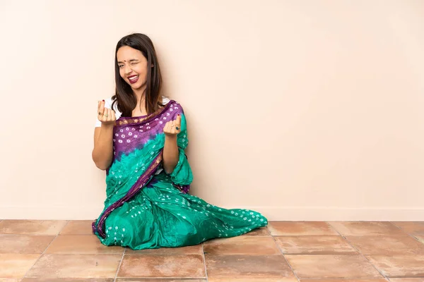 Young Indian Woman Sitting Floor Making Money Gesture — Stock Photo, Image
