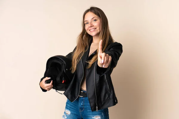 Молодая Литовская Женщина Мотоциклетным Шлемом Бежевом Фоне Показывает Поднимает Палец — стоковое фото