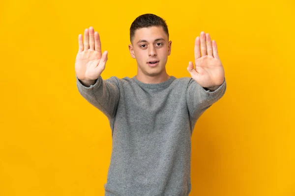 Young Caucasian Man Isolated Yellow Background Making Stop Gesture Disappointed — Stock Photo, Image