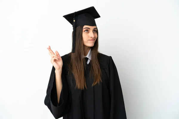 Graduado Universitario Joven Aislado Sobre Fondo Blanco Con Dedos Cruzando — Foto de Stock