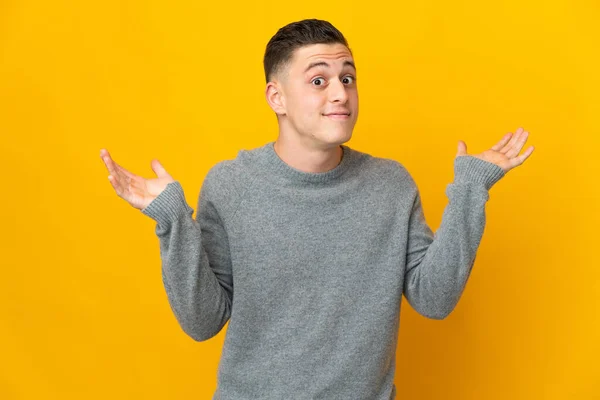 Young Caucasian Man Isolated Yellow Background Making Doubts Gesture — Stock Photo, Image