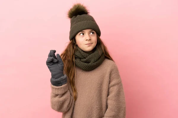 Little Girl Winter Hat Isolated Pink Background Fingers Crossing Wishing — Stock Photo, Image
